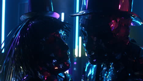 A-loving-diamond-couple-is-dancing-in-the-light-of-neon-ultraviolet-lamps.-Silver-Metallic-People-Dance-Glass-People-Show.